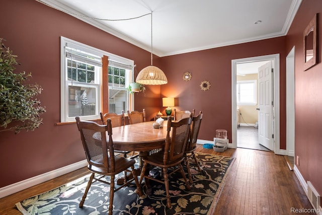 819 N Ball St, Owosso, MI 48867 - dining space with hardwood / wood-style floors, baseboards, and crown molding