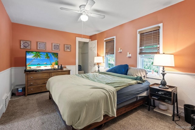 819 N Ball St, Owosso, MI 48867 - bedroom with carpet floors, ceiling fan, and a wainscoted wall