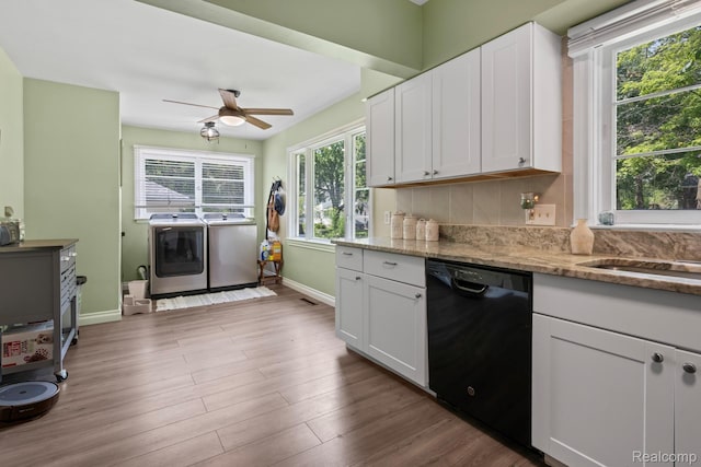 819 N Ball St, Owosso, MI 48867 - kitchen featuring dishwasher, washer and clothes dryer, baseboards, and white cabinets