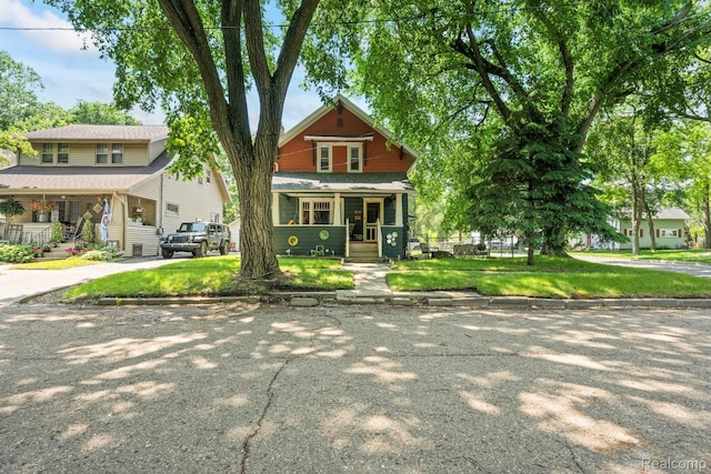 819 N Ball St, Owosso, MI 48867 - view of front of property with a porch, stairs, and a front yard