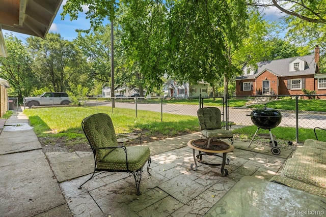 819 N Ball St, Owosso, MI 48867 - view of patio with a fire pit, area for grilling, and a residential view