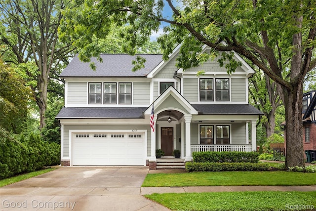 1017 N Maple Ave, Royal Oak, MI 48067 - view of front of home featuring a garage, driveway, covered porch, roof with shingles, and a front lawn
