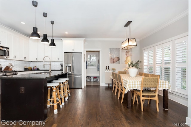 1017 N Maple Ave, Royal Oak, MI 48067 - kitchen featuring appliances with stainless steel finishes, a sink, healthy amount of natural light, dark stone countertops, and ornamental molding