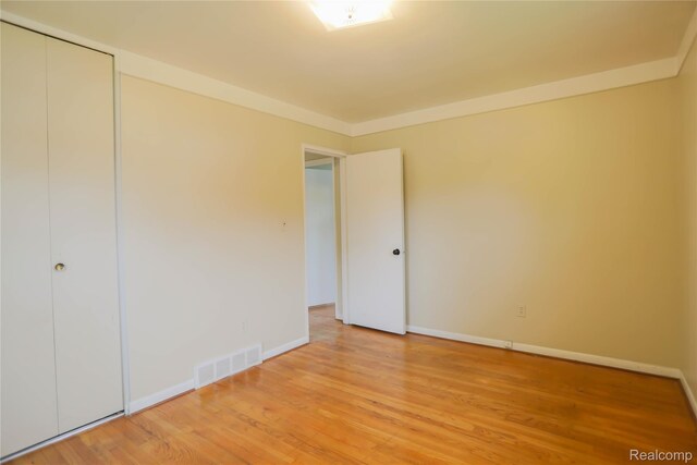 3581 Stolzenfeld Ave, Warren, MI 48091 - unfurnished bedroom featuring light wood finished floors, baseboards, and a closet