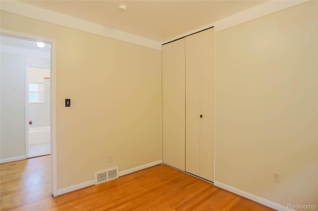 3581 Stolzenfeld Ave, Warren, MI 48091 - unfurnished bedroom featuring light wood-type flooring, a closet, and baseboards