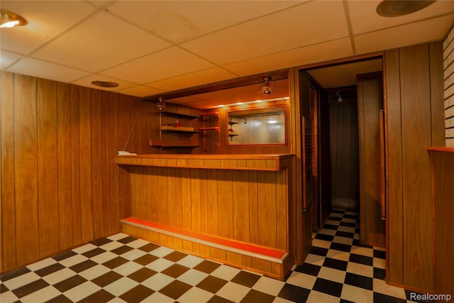 3581 Stolzenfeld Ave, Warren, MI 48091 - indoor dry bar with tile patterned floors, a paneled ceiling, and wood walls