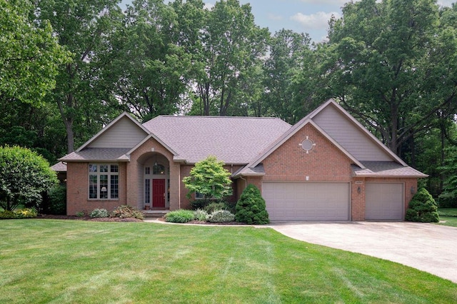 1480 Nelson Rd, Saint Joseph, MI 49085 - view of front of house featuring brick siding, concrete driveway, an attached garage, and a front lawn