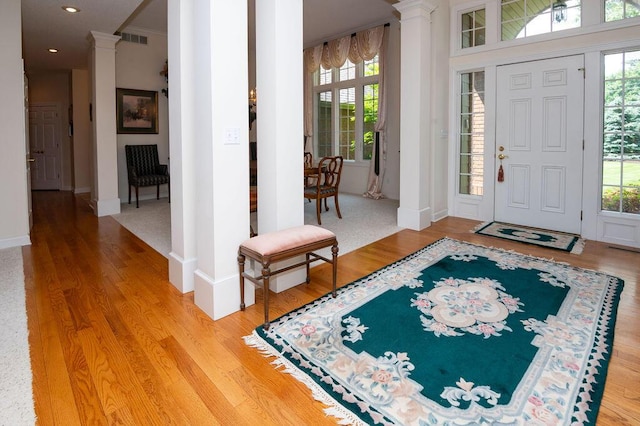 1480 Nelson Rd, Saint Joseph, MI 49085 - foyer entrance featuring decorative columns, light wood-style floors, healthy amount of natural light, crown molding, and recessed lighting