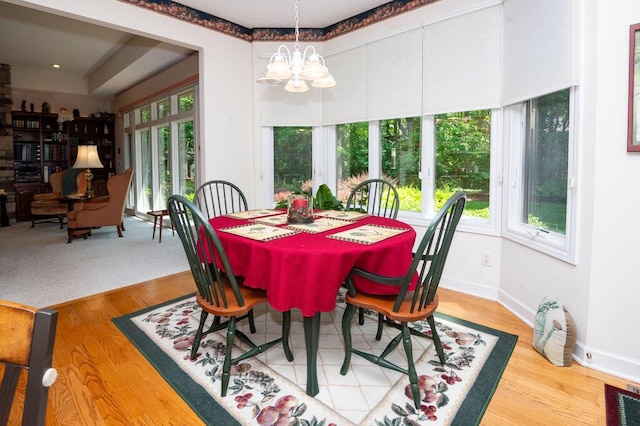 1480 Nelson Rd, Saint Joseph, MI 49085 - dining area with healthy amount of natural light, a chandelier, and wood finished floors