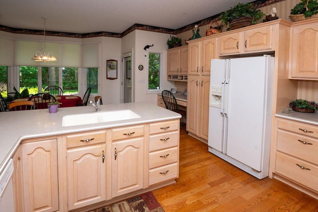 1480 Nelson Rd, Saint Joseph, MI 49085 - kitchen with white appliances, light brown cabinets, a sink, light wood-style floors, and light countertops