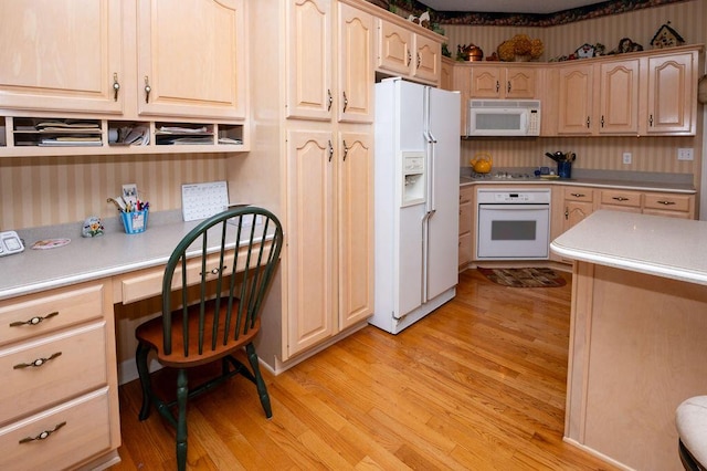 1480 Nelson Rd, Saint Joseph, MI 49085 - kitchen featuring white appliances, light countertops, light wood-style floors, light brown cabinetry, and wallpapered walls