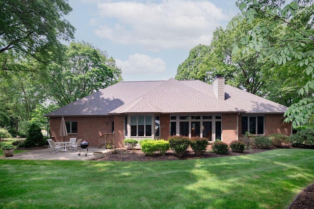 1480 Nelson Rd, Saint Joseph, MI 49085 - back of property featuring brick siding, a patio, a yard, and a chimney