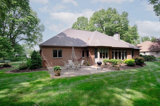 1480 Nelson Rd, Saint Joseph, MI 49085 - back of house with brick siding, a chimney, a patio area, and a lawn