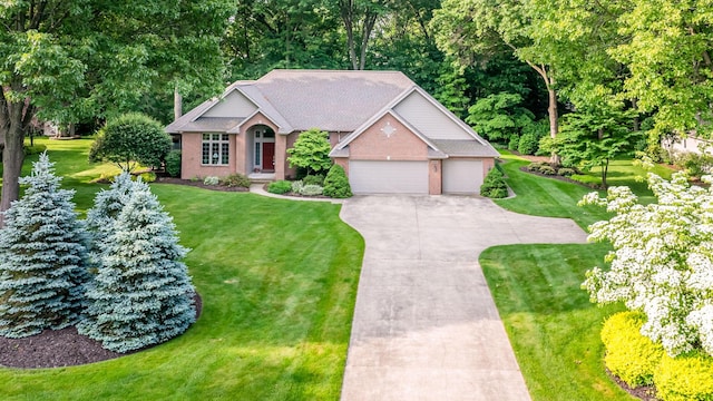 1480 Nelson Rd, Saint Joseph, MI 49085 - ranch-style house featuring concrete driveway, a front yard, and an attached garage