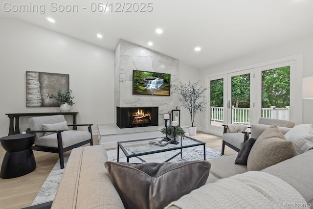 3405 Pine Estates Dr, Bloomfield Hills, MI 48323 - living area with vaulted ceiling, light wood finished floors, a fireplace, and recessed lighting