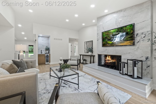 3405 Pine Estates Dr, Bloomfield Hills, MI 48323 - living room featuring wine cooler, light wood finished floors, recessed lighting, and a high end fireplace