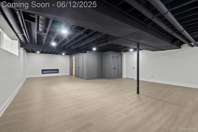 3405 Pine Estates Dr, Bloomfield Hills, MI 48323 - finished basement featuring wood finished floors and a glass covered fireplace