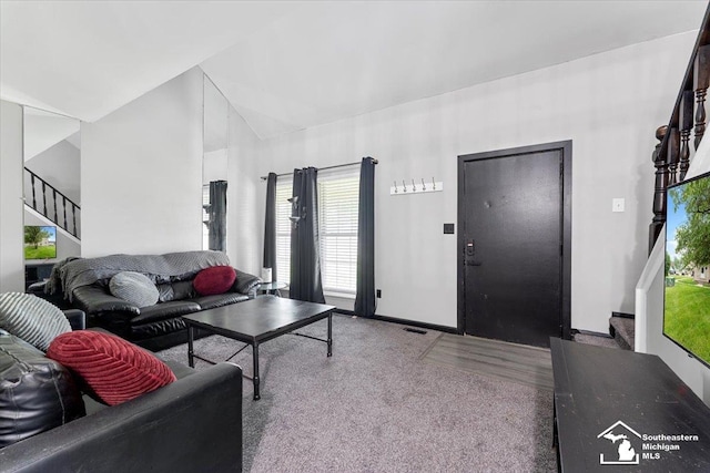 20036 Village Green Ct, Brownstown, MI 48183 - carpeted living room with stairway, healthy amount of natural light, lofted ceiling, and baseboards
