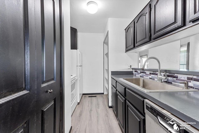 20036 Village Green Ct, Brownstown, MI 48183 - kitchen with stainless steel dishwasher, a sink, light wood finished floors, and dark cabinetry