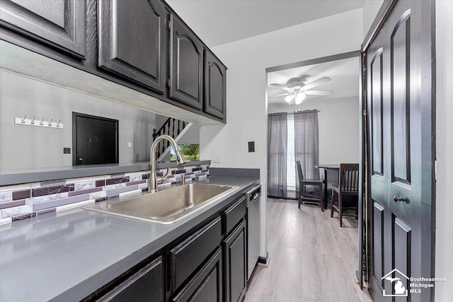 20036 Village Green Ct, Brownstown, MI 48183 - kitchen with a sink, stainless steel dishwasher, a ceiling fan, light wood finished floors, and dark cabinetry