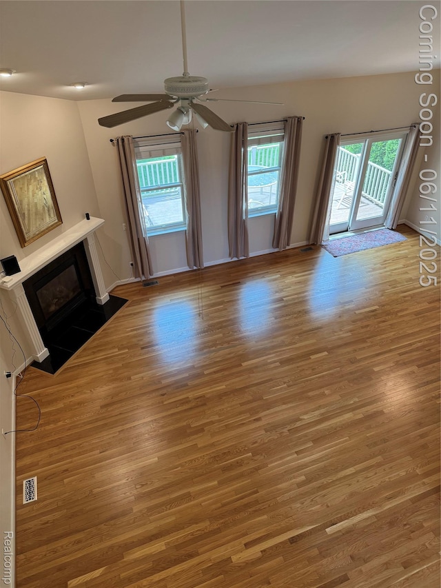 34444 Fargo St, Livonia, MI 48152 - unfurnished living room with wood finished floors, ceiling fan, and a fireplace with flush hearth