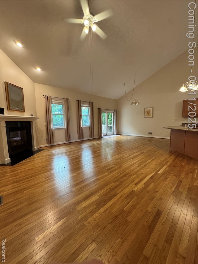 34444 Fargo St, Livonia, MI 48152 - unfurnished living room with wood-type flooring, a fireplace with flush hearth, ceiling fan, and high vaulted ceiling