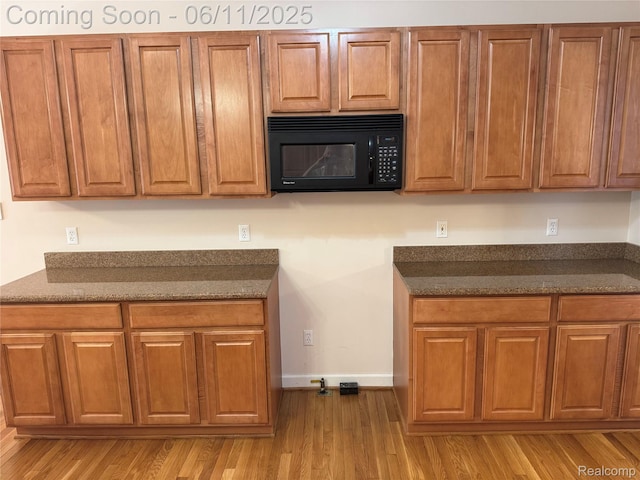 34444 Fargo St, Livonia, MI 48152 - kitchen featuring black microwave, wood finished floors, and brown cabinetry