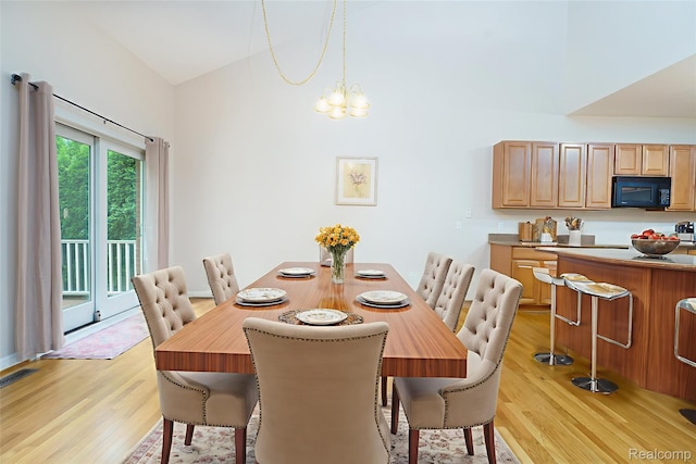 34444 Fargo St, Livonia, MI 48152 - dining space featuring light wood finished floors, lofted ceiling, and a chandelier
