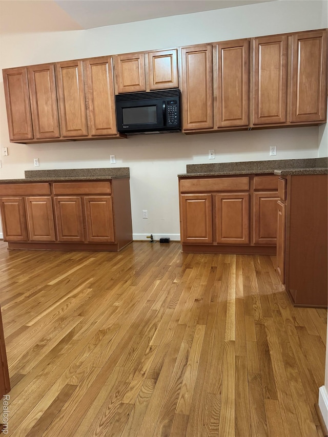 34444 Fargo St, Livonia, MI 48152 - kitchen with black microwave, light wood finished floors, and brown cabinets