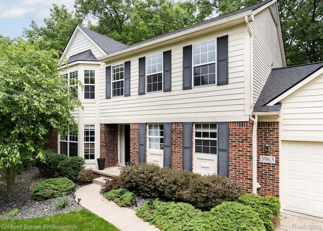 5963 James Head Ct, West Bloomfield, MI 48324 - view of front of house featuring an attached garage and brick siding