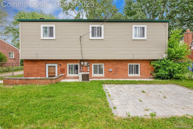 24113 Karen Ave, Warren, MI 48091 - back of house featuring central AC unit, brick siding, and a patio