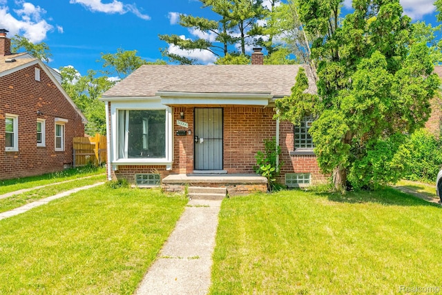 20069 Goulburn St, Detroit, MI 48205 - bungalow-style house featuring brick siding, a chimney, and a shingled roof