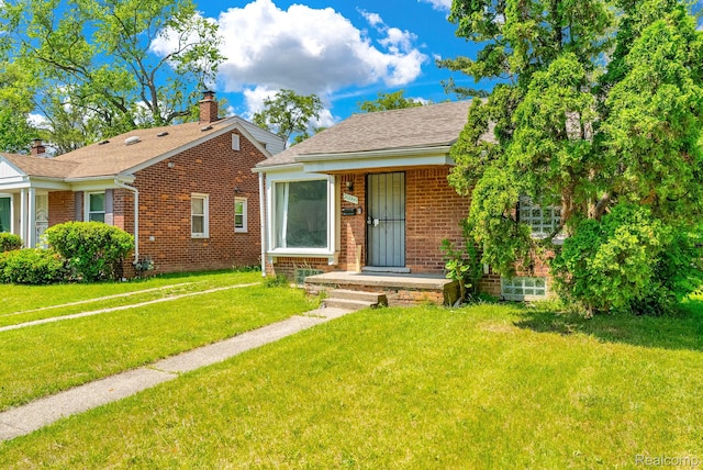 20069 Goulburn St, Detroit, MI 48205 - bungalow-style house featuring brick siding, a front yard, a shingled roof, and a chimney