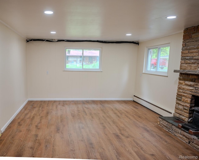 46254 Custer Ave, Utica, MI 48317 - below grade area featuring a baseboard radiator, wood finished floors, and recessed lighting