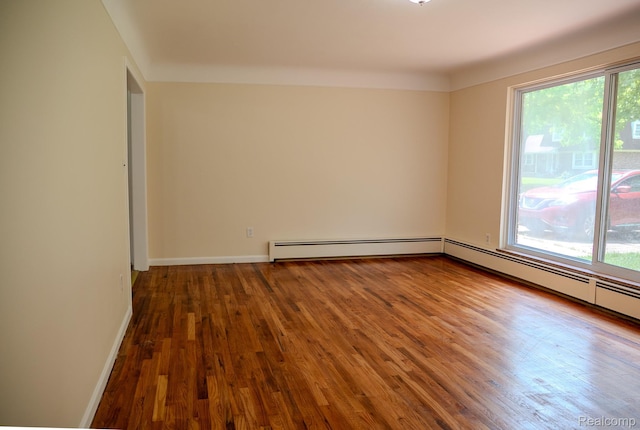 46254 Custer Ave, Utica, MI 48317 - spare room featuring wood finished floors and baseboard heating
