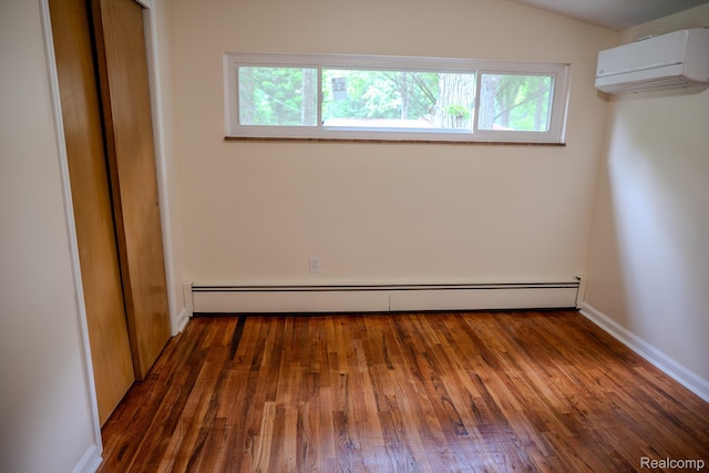 46254 Custer Ave, Utica, MI 48317 - unfurnished bedroom featuring a wall mounted AC, a baseboard heating unit, and wood-type flooring