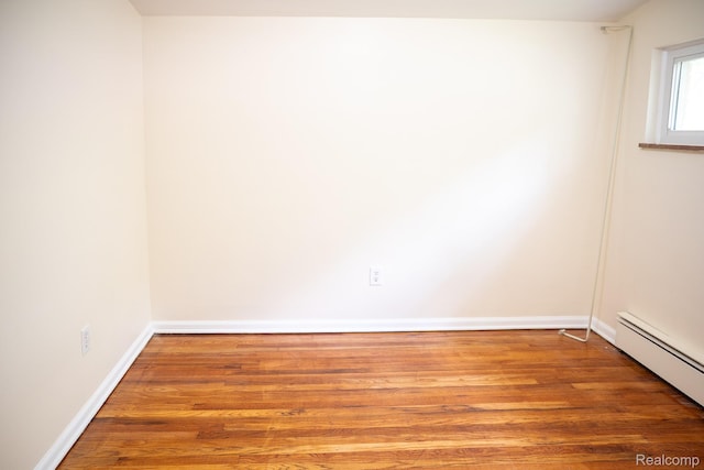 46254 Custer Ave, Utica, MI 48317 - spare room with a baseboard heating unit and wood finished floors