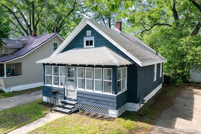 884 Emerson Ave, Muskegon, MI 49442 - view of front of house featuring entry steps, a chimney, and crawl space