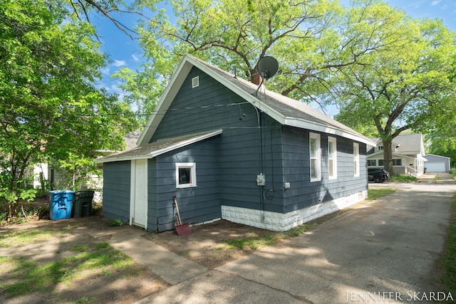 884 Emerson Ave, Muskegon, MI 49442 - view of property exterior featuring roof with shingles