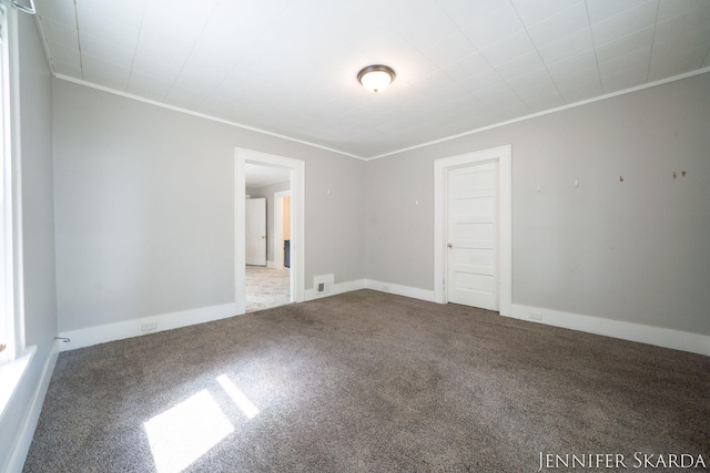 884 Emerson Ave, Muskegon, MI 49442 - unfurnished room with carpet, crown molding, and baseboards