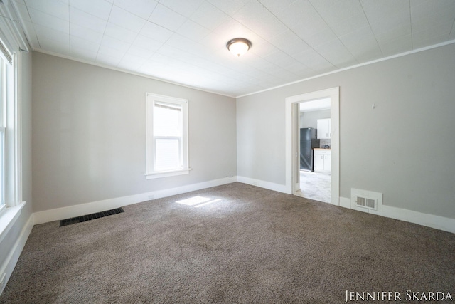 884 Emerson Ave, Muskegon, MI 49442 - unfurnished room featuring carpet floors, crown molding, and baseboards