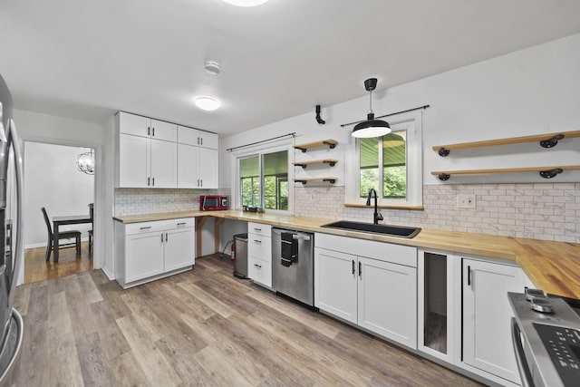2618 Greencliff Dr, East Lansing, MI 48823 - kitchen with butcher block countertops, a sink, stainless steel appliances, open shelves, and tasteful backsplash