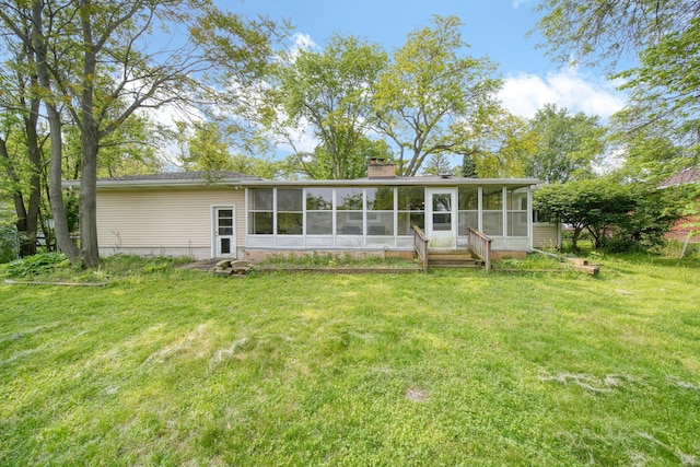 2618 Greencliff Dr, East Lansing, MI 48823 - back of property featuring a sunroom, a yard, and a chimney