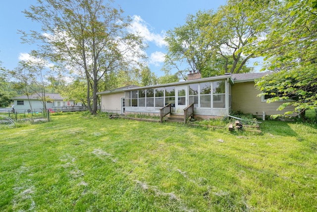 2618 Greencliff Dr, East Lansing, MI 48823 - rear view of house featuring a sunroom and a chimney