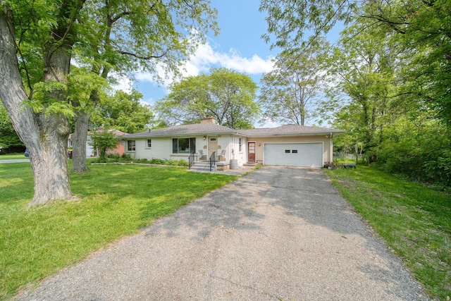 2618 Greencliff Dr, East Lansing, MI 48823 - ranch-style home with an attached garage, asphalt driveway, a chimney, and a front yard