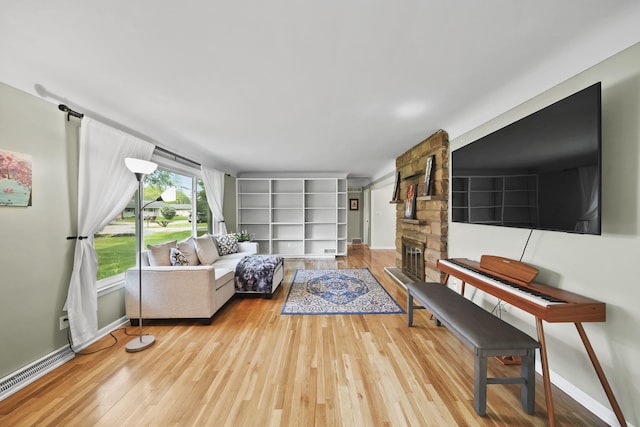 2618 Greencliff Dr, East Lansing, MI 48823 - living area with wood finished floors, baseboards, and a stone fireplace