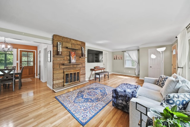 2618 Greencliff Dr, East Lansing, MI 48823 - living area featuring wood finished floors, plenty of natural light, baseboards, and a chandelier