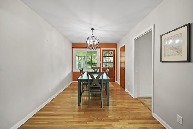2618 Greencliff Dr, East Lansing, MI 48823 - dining space featuring a chandelier, light wood finished floors, and baseboards