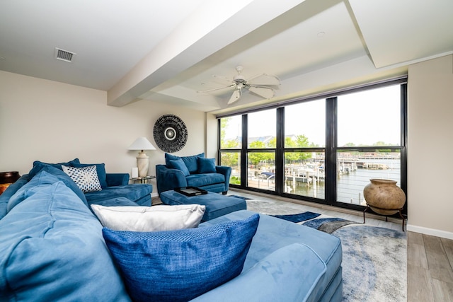 240 Water St Unit 1A, Saint Joseph, MI 49085 - living area with wood finished floors, a ceiling fan, baseboards, and a water view