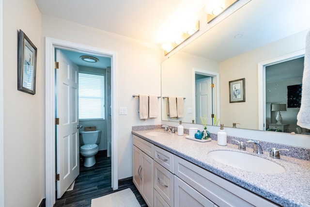 240 Water St Unit 1A, Saint Joseph, MI 49085 - full bath with toilet, double vanity, wood finished floors, and baseboards